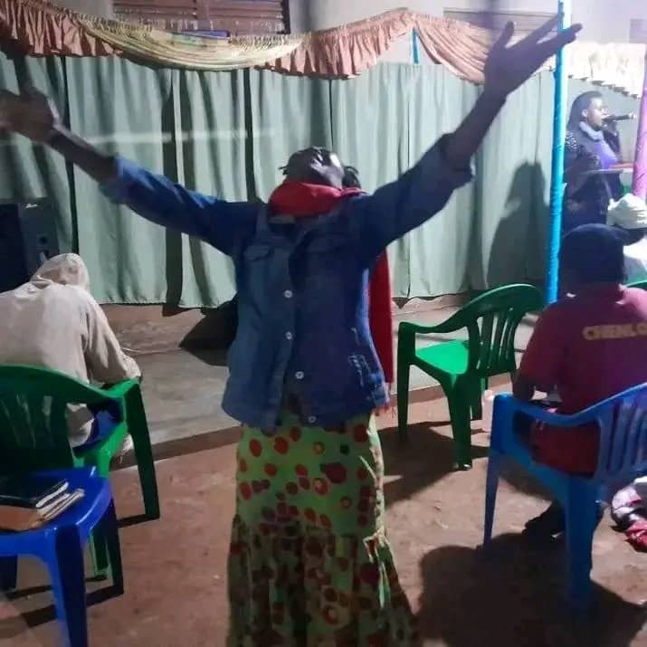 Worship and prayer during outreach in Buwenge
