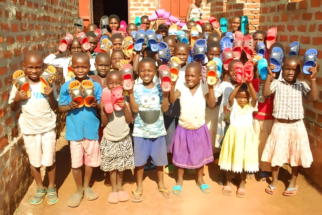 Children with new sandals from clothing support